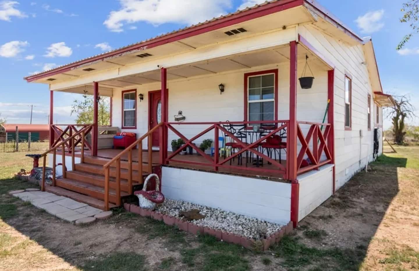 Covered front porch with red railings